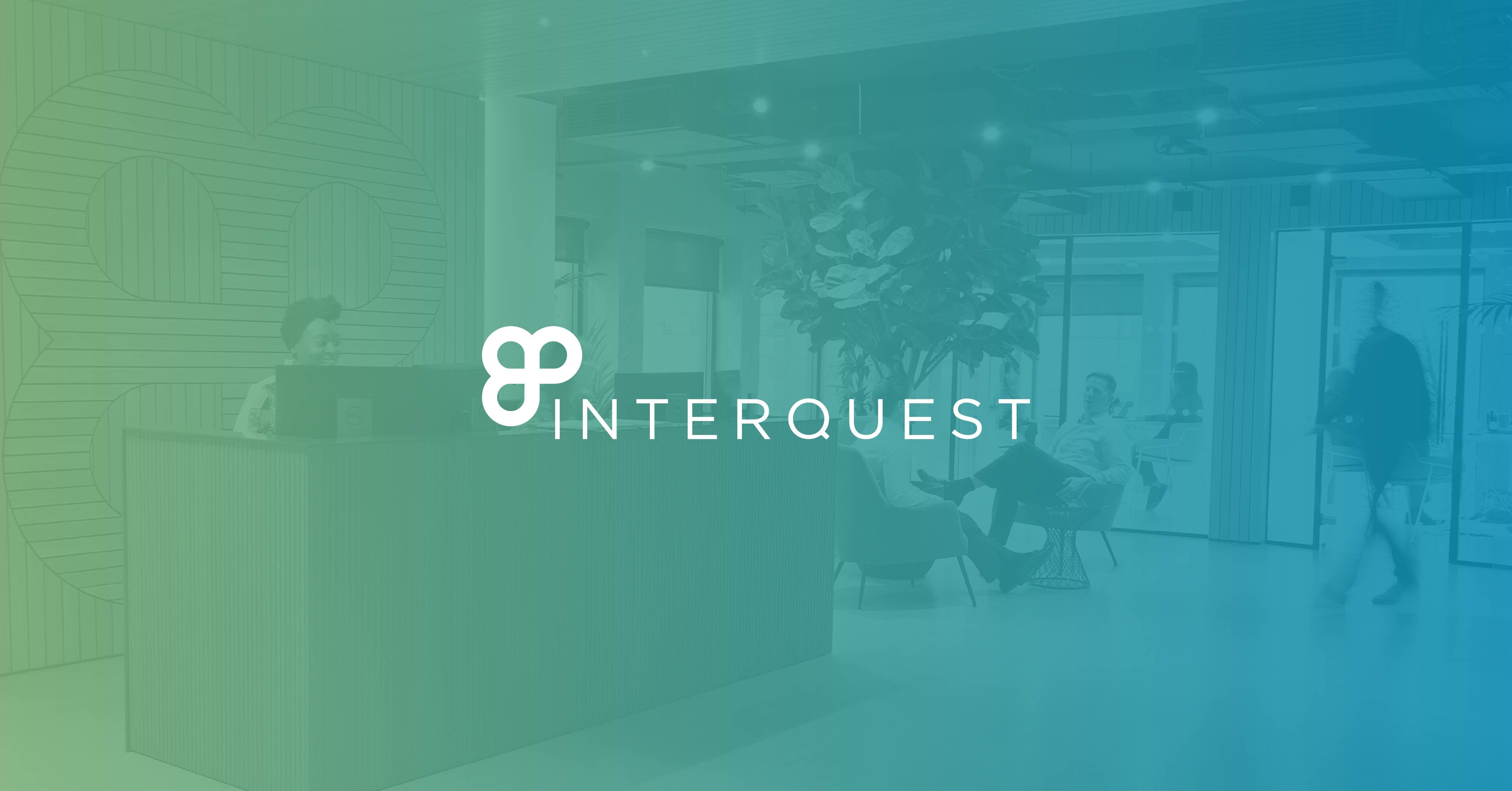 White InterQuest logo on a background image of InterQuest Group's reception area green and blue filter