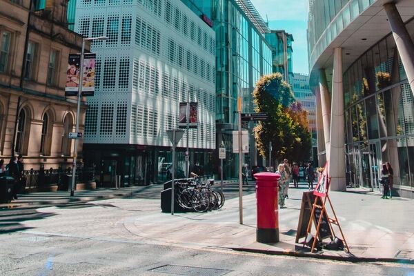 image of a red phone box on the corner of a street in manchester