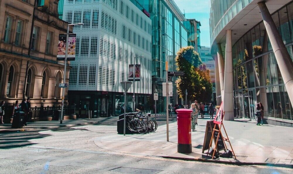 image of a red phone box on the corner of a street in manchester