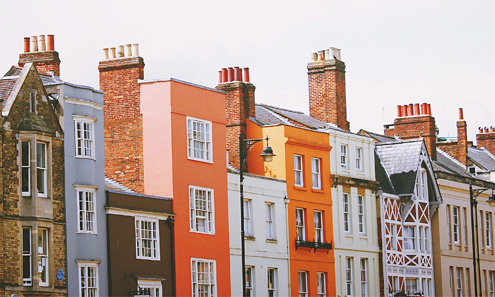 A photo of a row of buildings with painted exterior walls