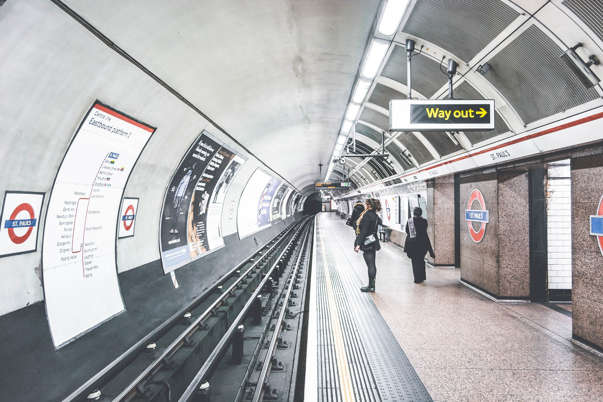 A photo of a London Underground platform taken at the edge looking down the tracks